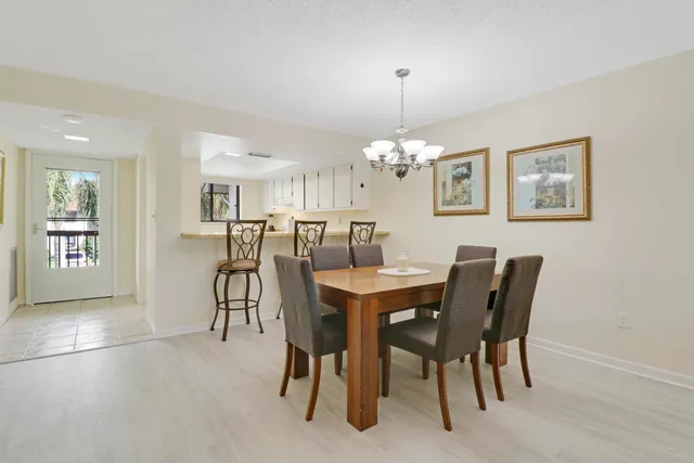 a view of a dining room with furniture and chandelier