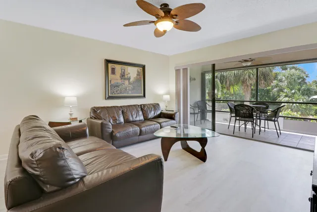 a living room with couches and a chandelier