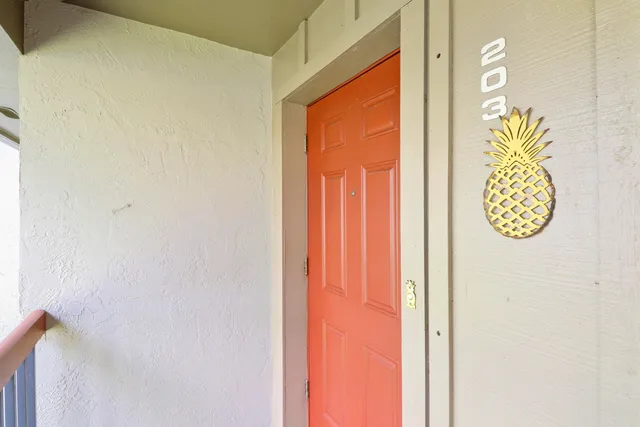 a kitchen with white cabinets and a window