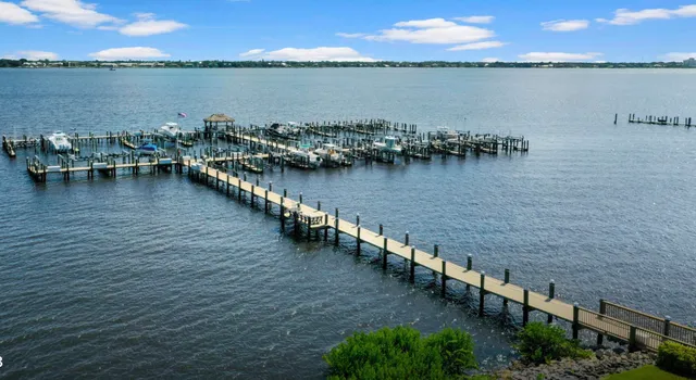 a view of a lake with wooden floor and bridge