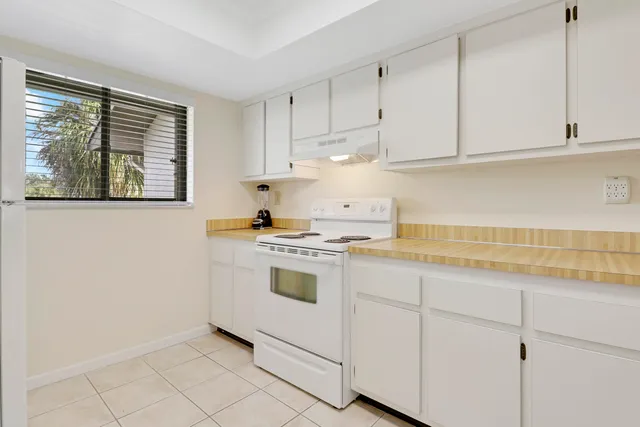 a kitchen with a refrigerator and window