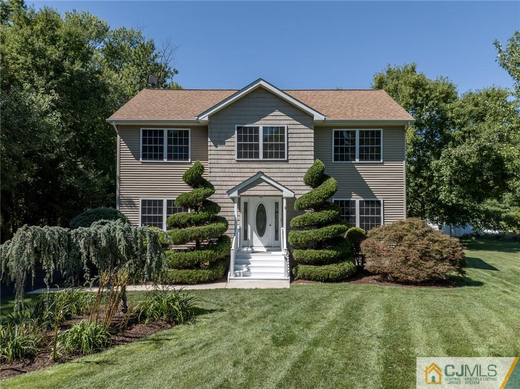 a front view of house with a garden