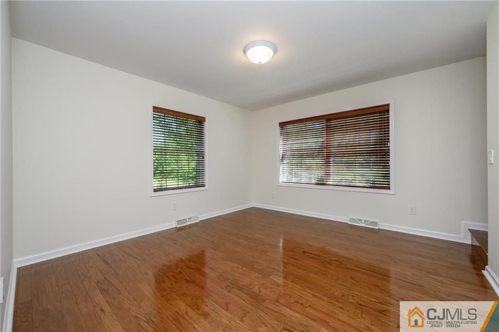 20 Blue Jay Hill Road Westampton, NJ 08060 - Photo 11 of 65 an empty room with wooden floor and windows