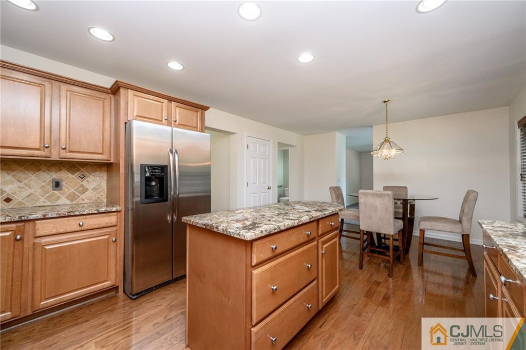 20 Blue Jay Hill Road Westampton, NJ 08060 - Photo 15 of 65 a kitchen that has a table chairs in it wooden floors and white cabinets