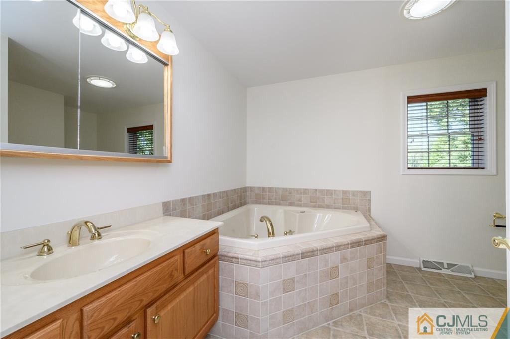 20 Blue Jay Hill Road Westampton, NJ 08060 - Photo 26 of 65 a bathroom with a tub sink and mirror