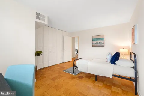 a bedroom with a bed and a cabinets