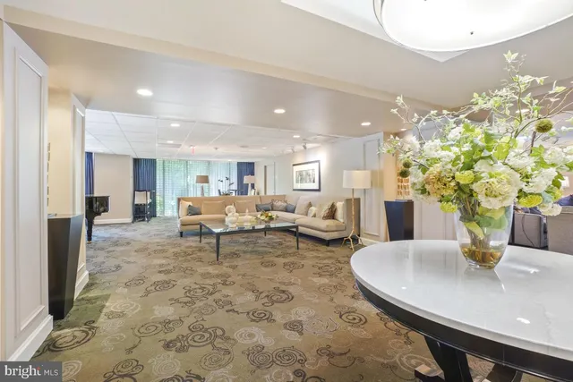 a dining hall with stainless steel appliances granite countertop a dining table and chairs with wooden floor