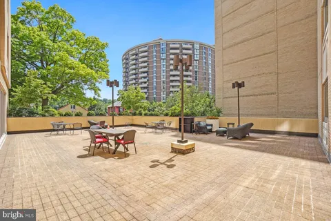 a view of a big yard with swimming pool and green space
