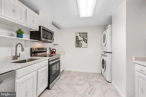 a kitchen with a sink and a stove top oven
