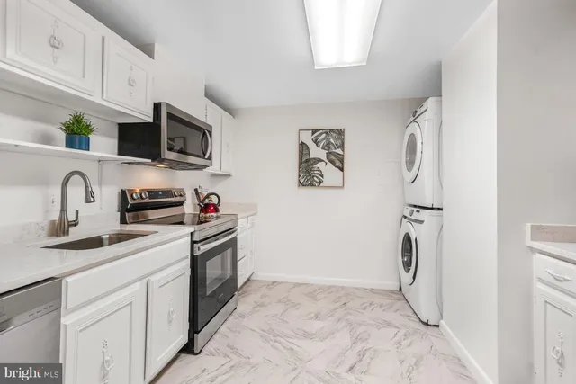 a kitchen with a sink and a stove top oven