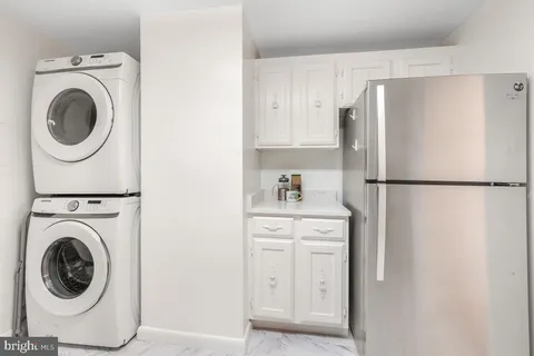 a kitchen with a refrigerator and washer