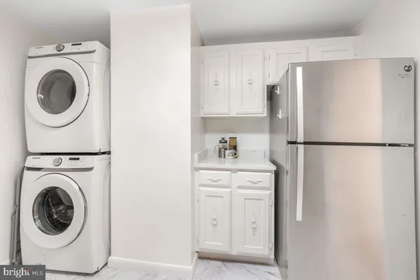 a kitchen with a refrigerator and washer