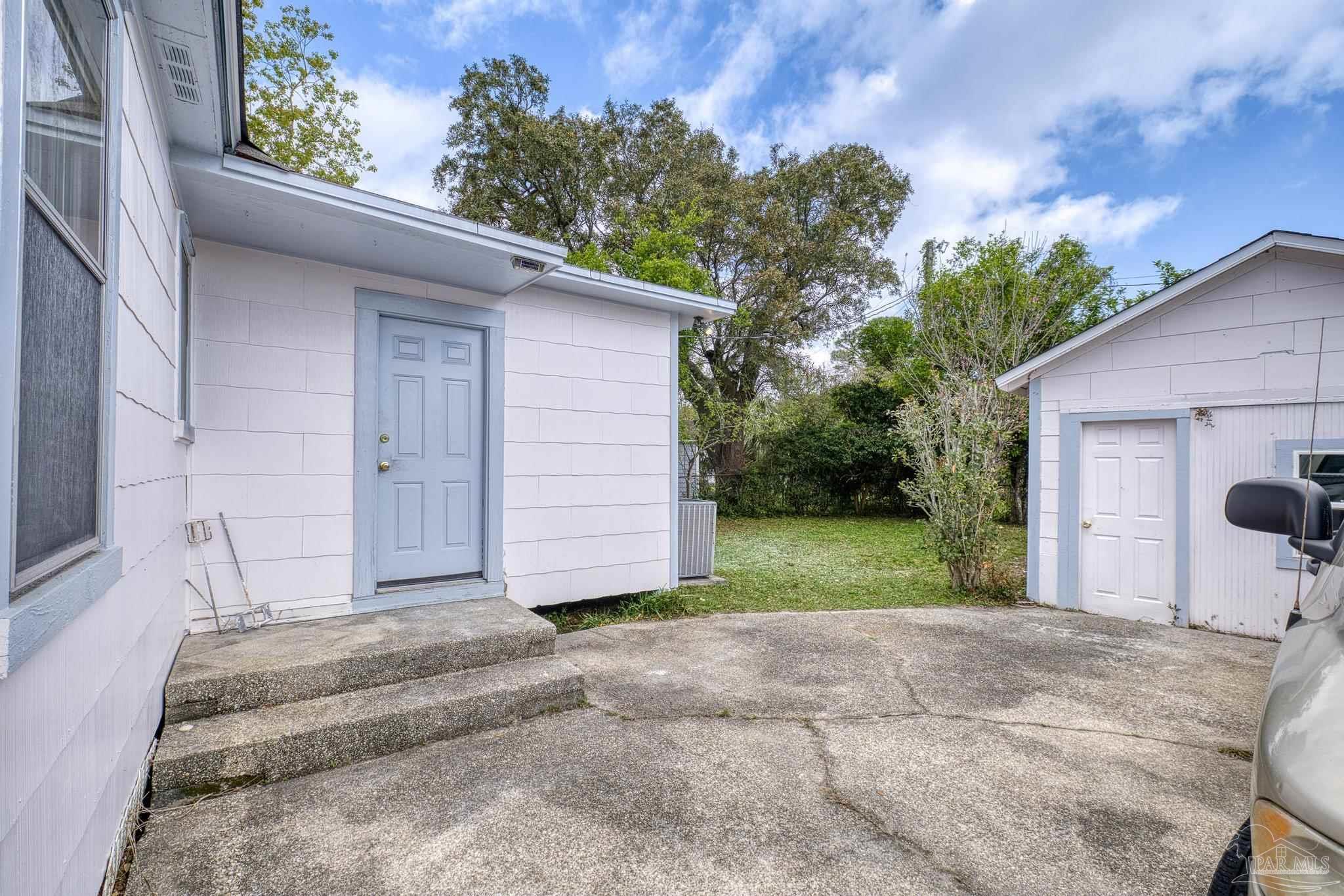 208 Berry Road Pensacola, FL 32507 - Photo 32 of 41 a view of backyard with large trees and plants