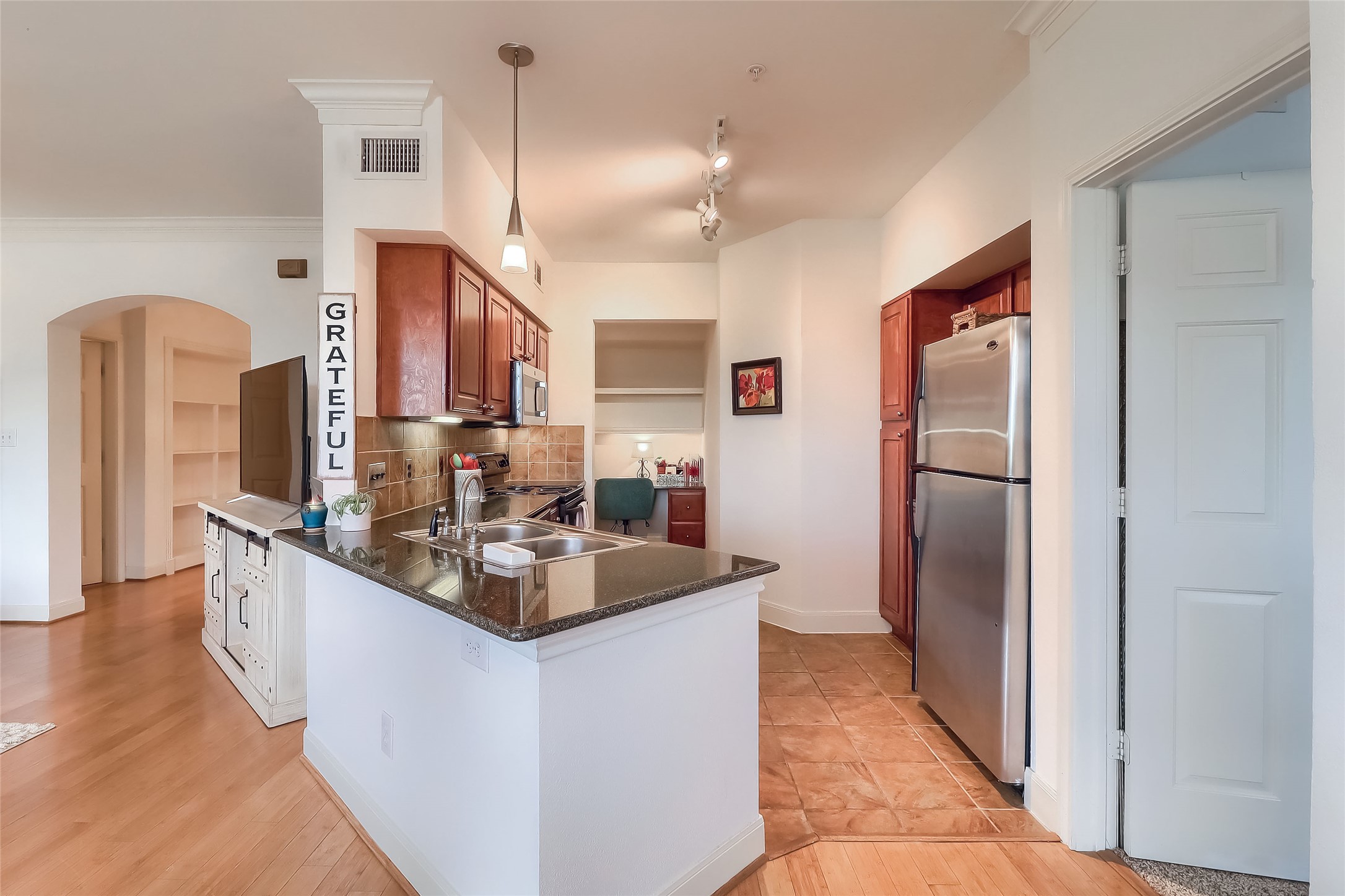 7701 Rialto Boulevard, Unit 1128 Austin, TX 78735 - Photo 8 of 35 a kitchen with stainless steel appliances granite countertop a refrigerator and a sink