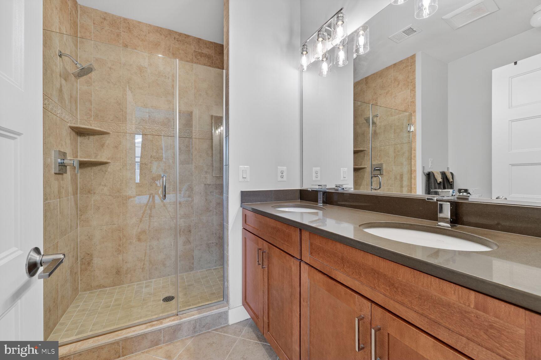 3328 7th Street Northeast Washington, DC 20017 - Photo 14 of 30 a bathroom with a double vanity sink mirror and shower