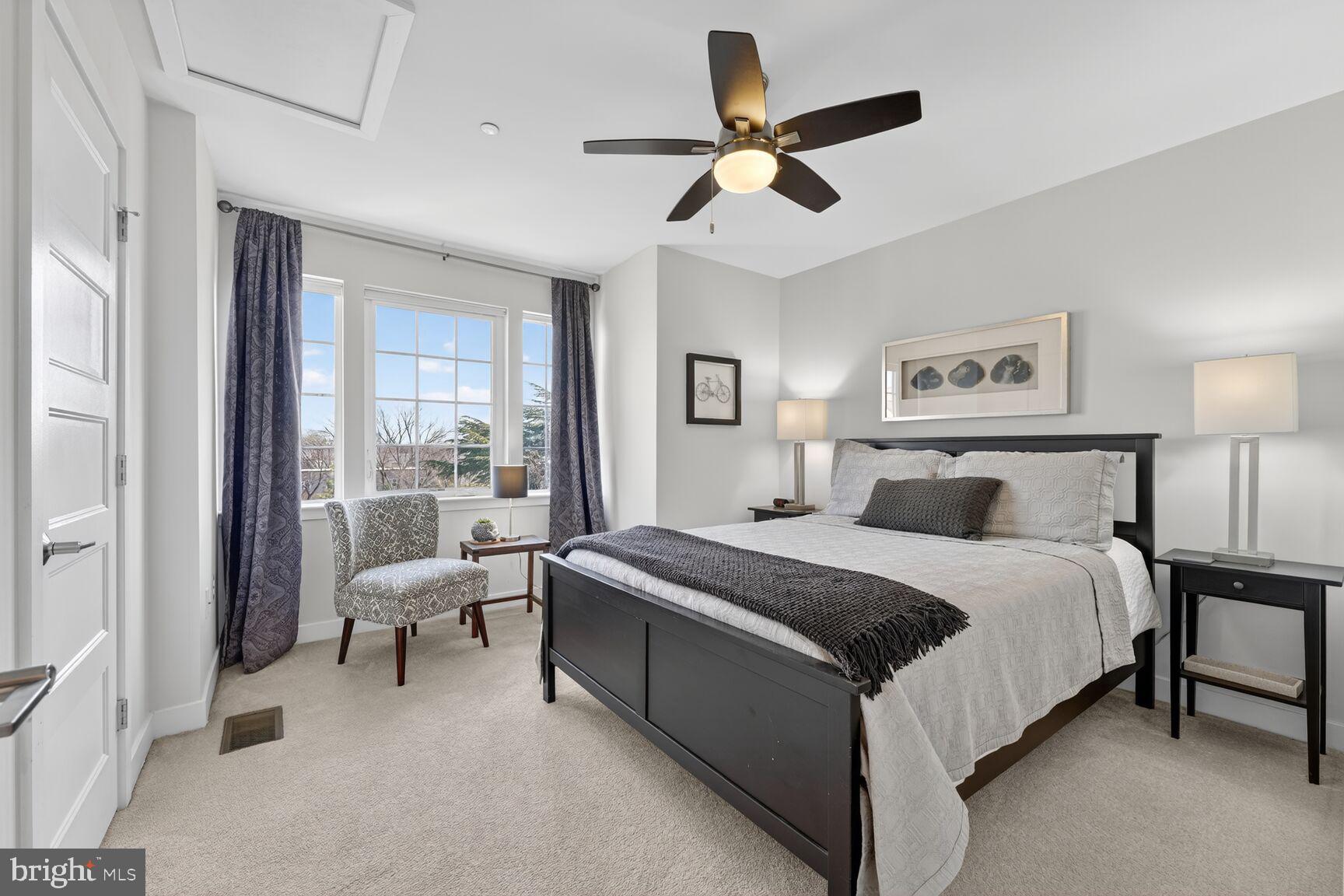 3328 7th Street Northeast Washington, DC 20017 - Photo 19 of 30 a spacious bedroom with a bed and a chandelier