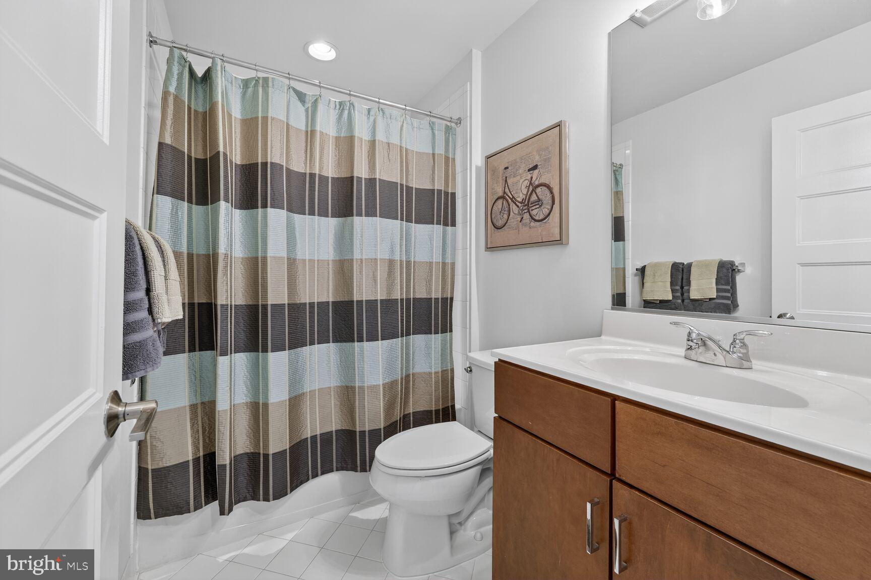 3328 7th Street Northeast Washington, DC 20017 - Photo 20 of 30 a bathroom with a sink a toilet a shower and a mirror