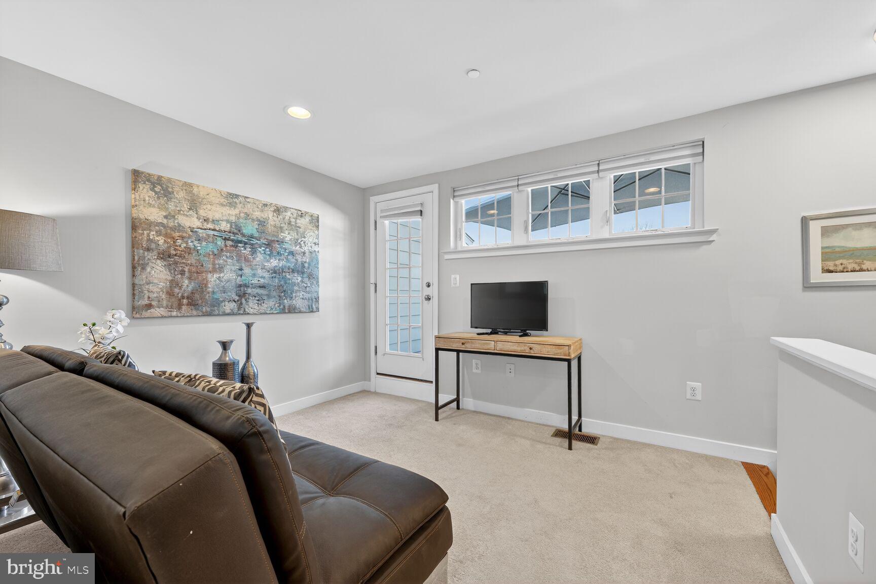 3328 7th Street Northeast Washington, DC 20017 - Photo 21 of 30 a living room with furniture a window and a flat screen tv