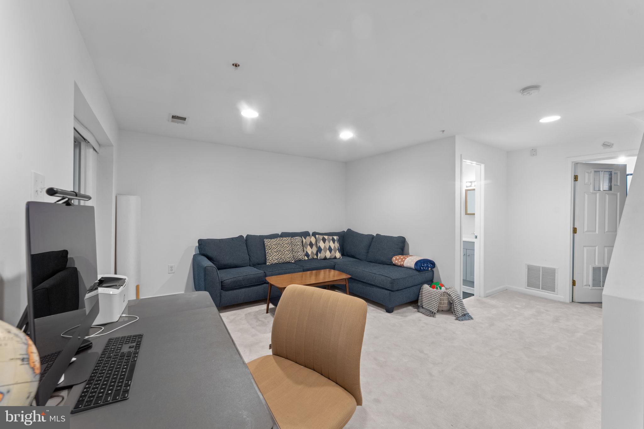 12705 Hawkshead Terrace Silver Spring, MD 20904 - Photo 31 of 52 a living room with furniture and a flat screen tv