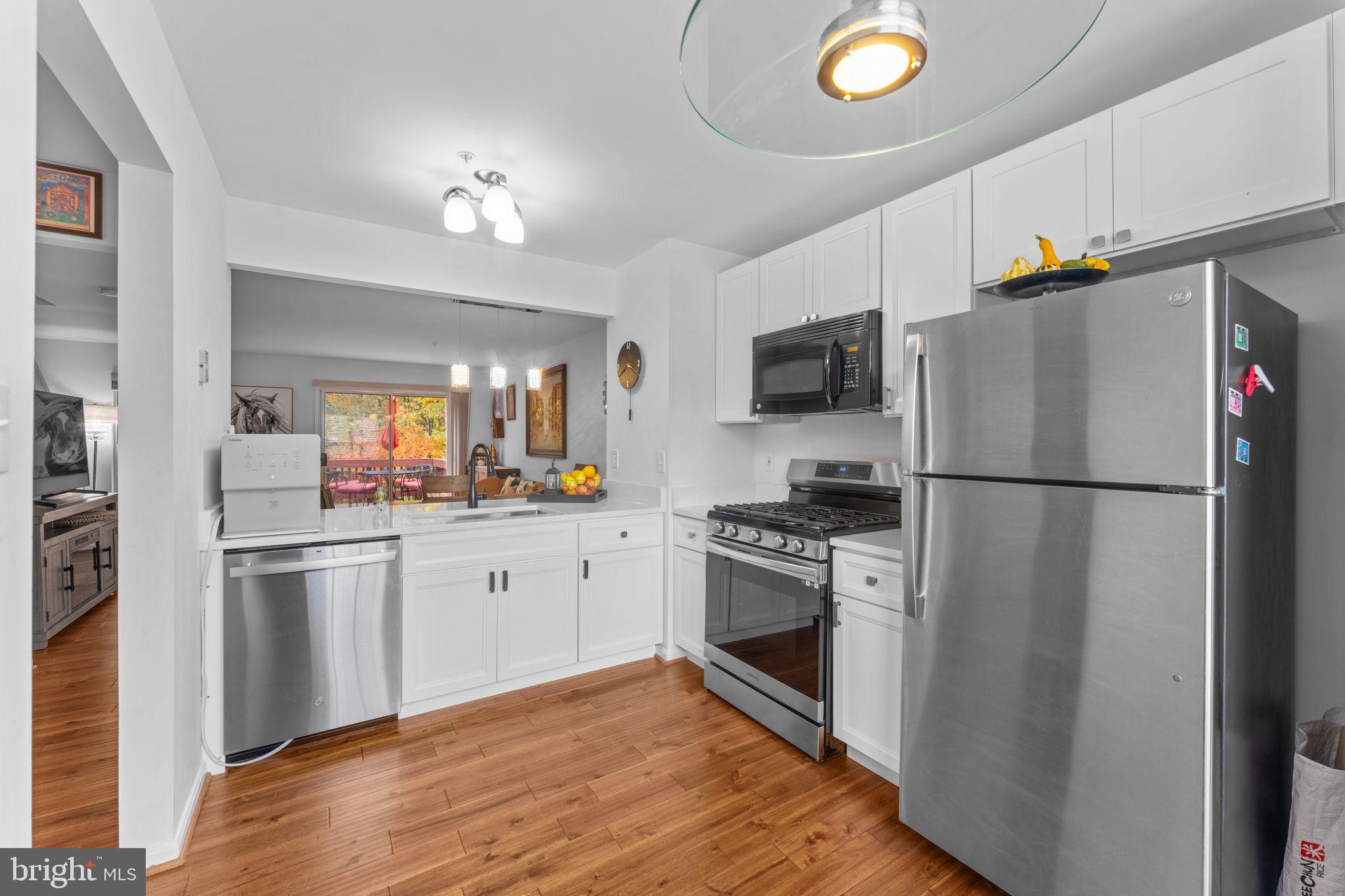 12705 Hawkshead Terrace Silver Spring, MD 20904 - Photo 9 of 52 a kitchen with granite countertop a refrigerator stove top oven and sink