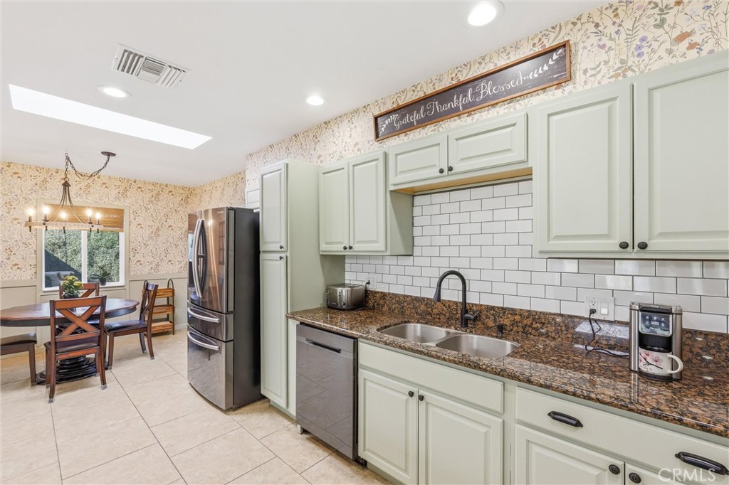 11 E Crescent Redlands, CA 92373 - Photo 14 of 35 a kitchen with granite countertop a sink cabinets and stainless steel appliances