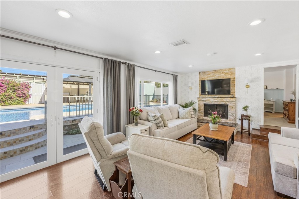 11 E Crescent Redlands, CA 92373 - Photo 17 of 35 a living room with furniture a fireplace and a flat screen tv