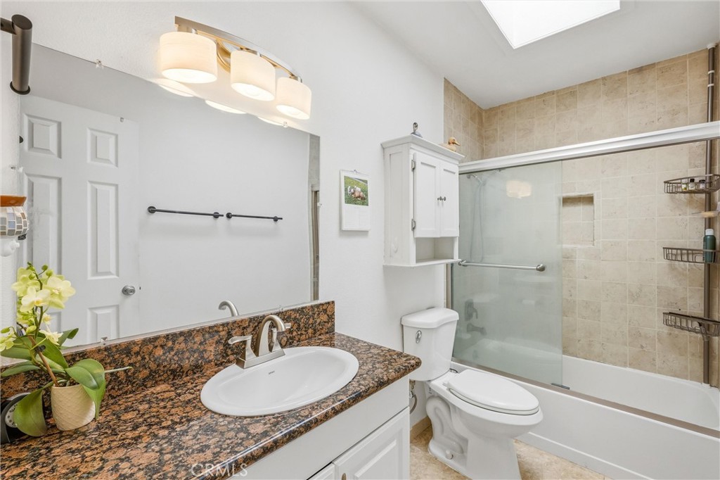 11 E Crescent Redlands, CA 92373 - Photo 29 of 35 a bathroom with a granite countertop sink toilet a mirror and shower