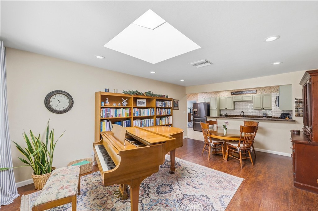 11 E Crescent Redlands, CA 92373 - Photo 7 of 35 a living room with furniture a rug and a bookshelf