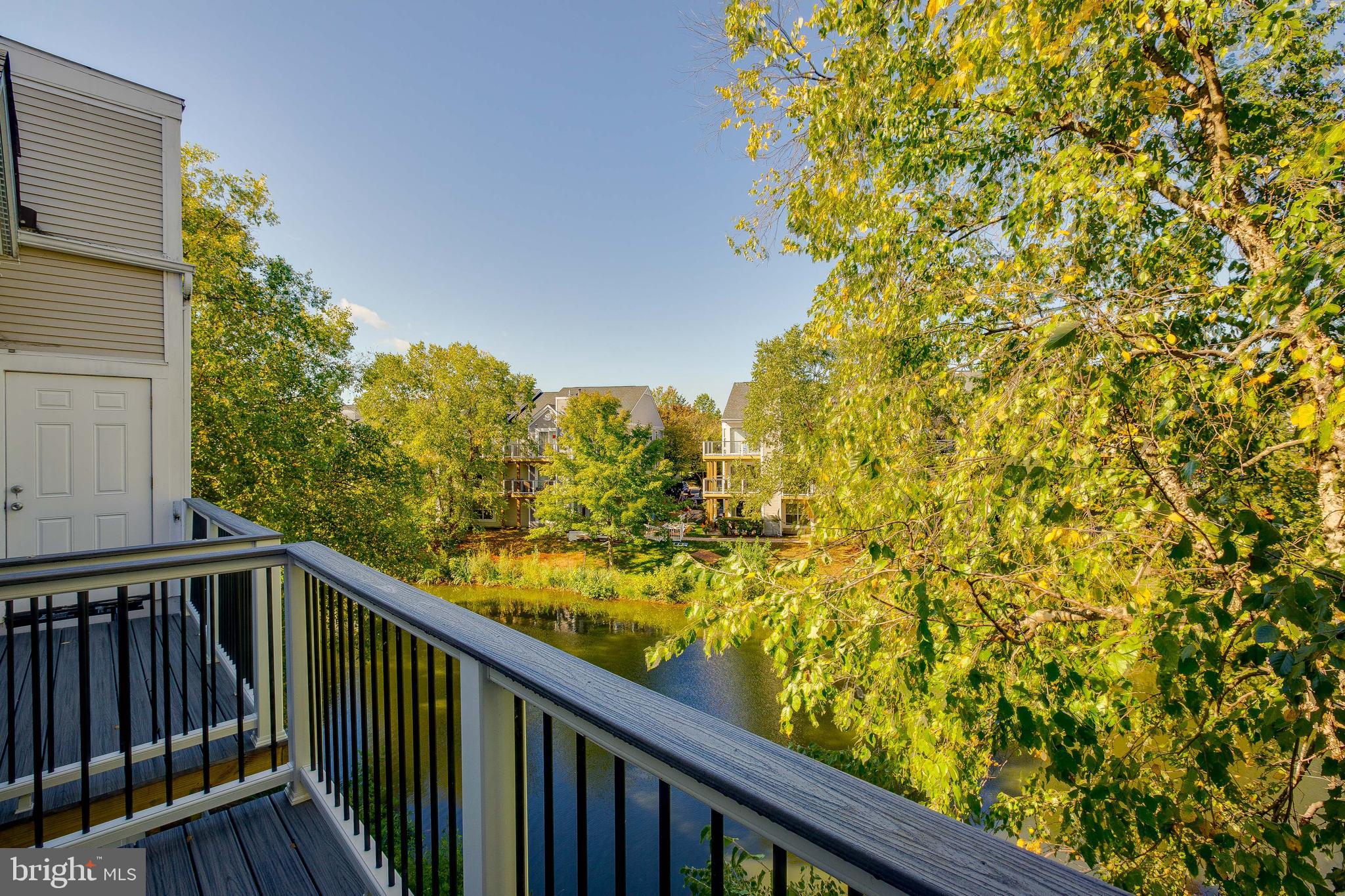 20575 Snowshoe Square, Unit 302 Ashburn, VA 20147 - Photo 11 of 32 a view of a balcony with wooden fence