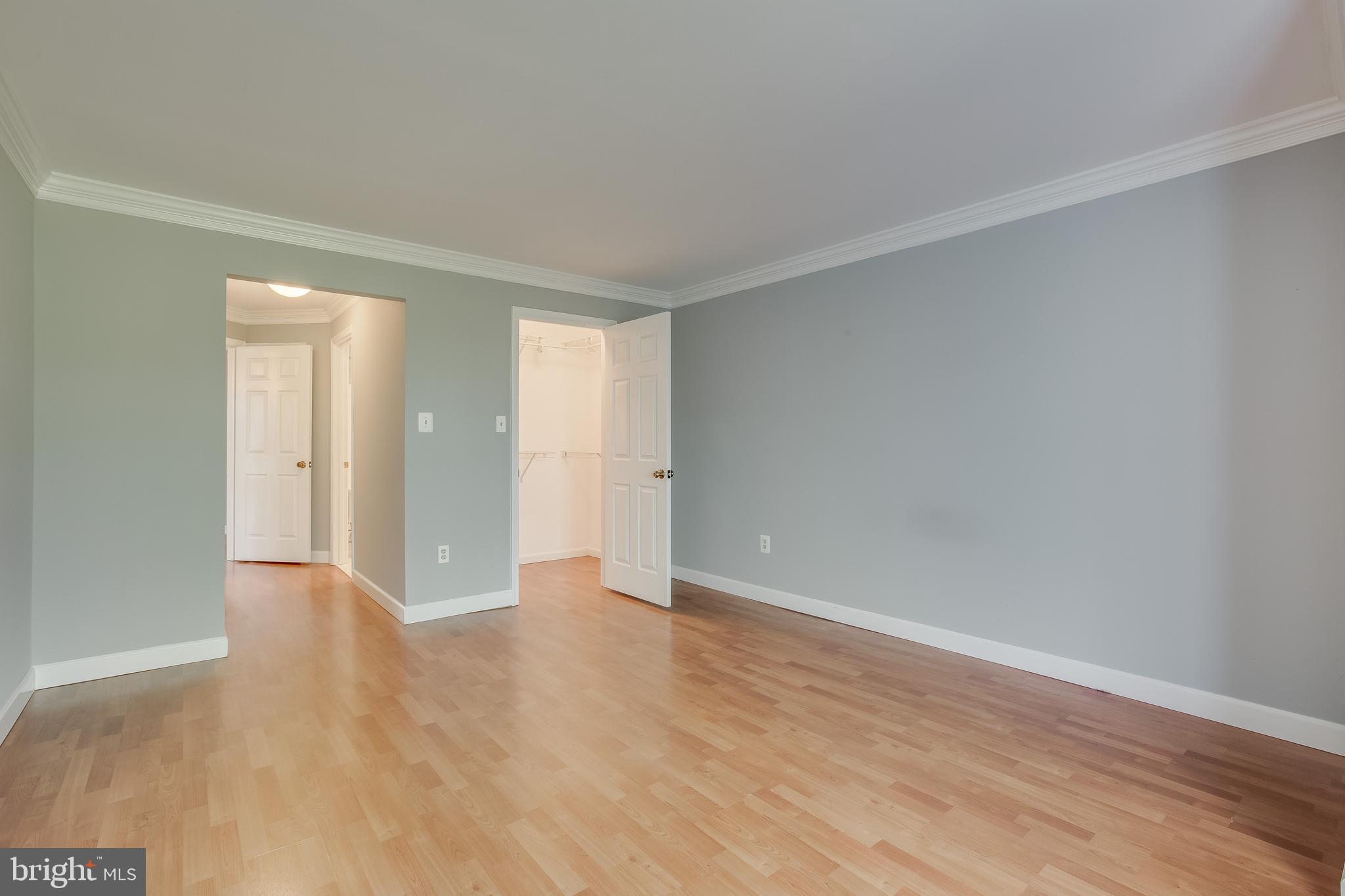 20575 Snowshoe Square, Unit 302 Ashburn, VA 20147 - Photo 14 of 32 a view of an empty room and wooden floor