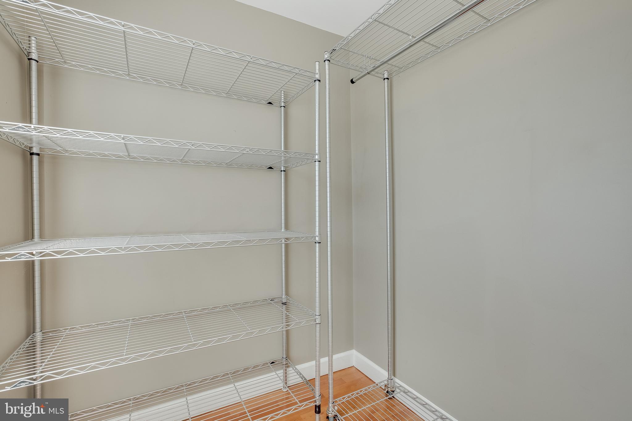 20575 Snowshoe Square, Unit 302 Ashburn, VA 20147 - Photo 20 of 32 a view of walk in closet with empty racks