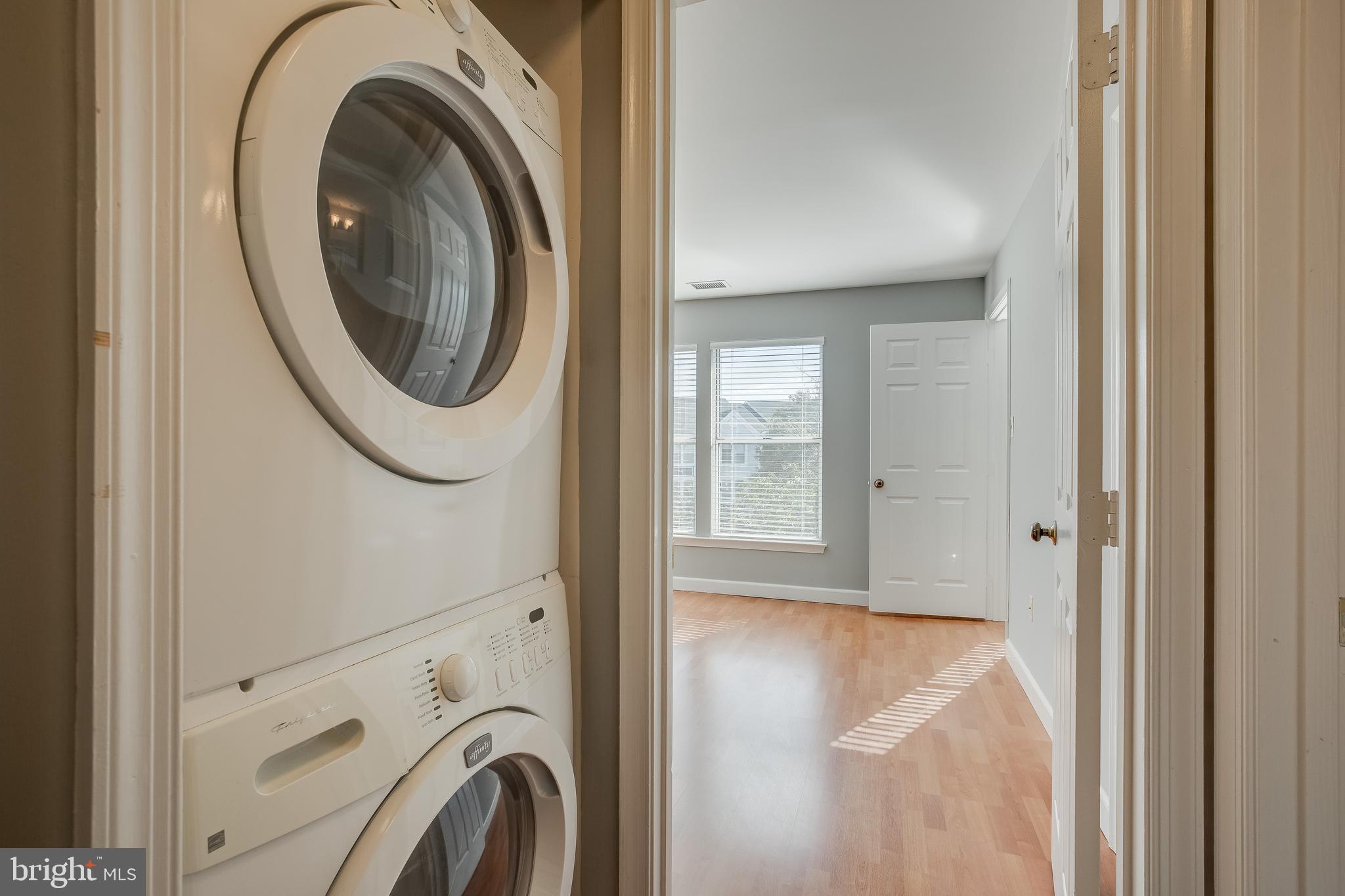 20575 Snowshoe Square, Unit 302 Ashburn, VA 20147 - Photo 10 of 32 a view of a hallway with washer and dryer
