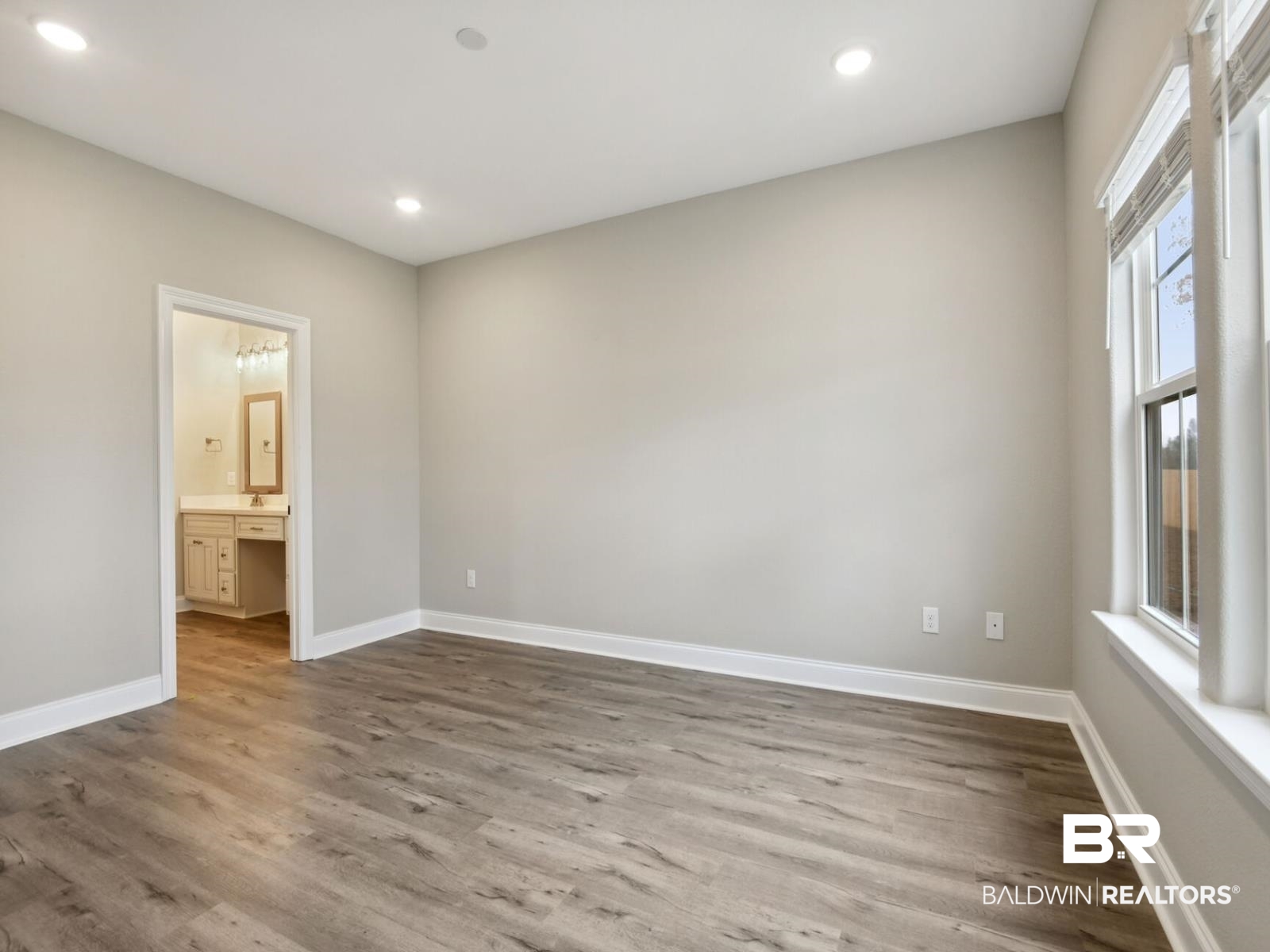 12922 Gondala Street Elberta, AL 36530 - Photo 18 of 20 Unfurnished bedroom with dark wood-style floors, recessed lighting, and ensuite bath