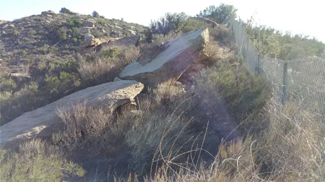 a view of a yard with wooden fence
