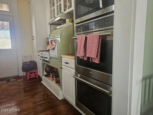 a utility room with stainless steel appliances and cabinets