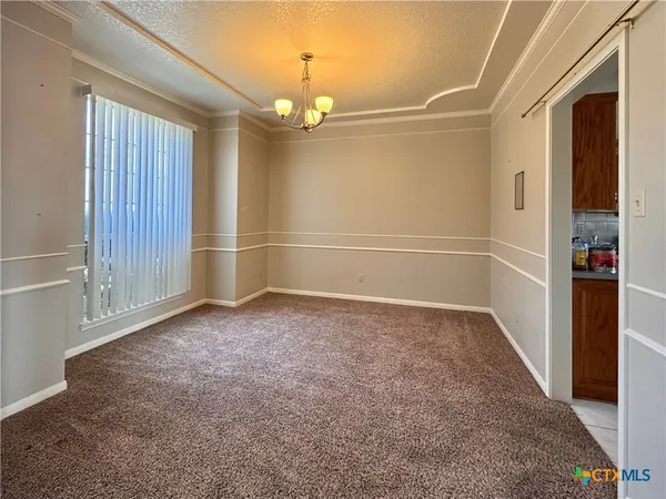 an empty room with windows and wooden floor