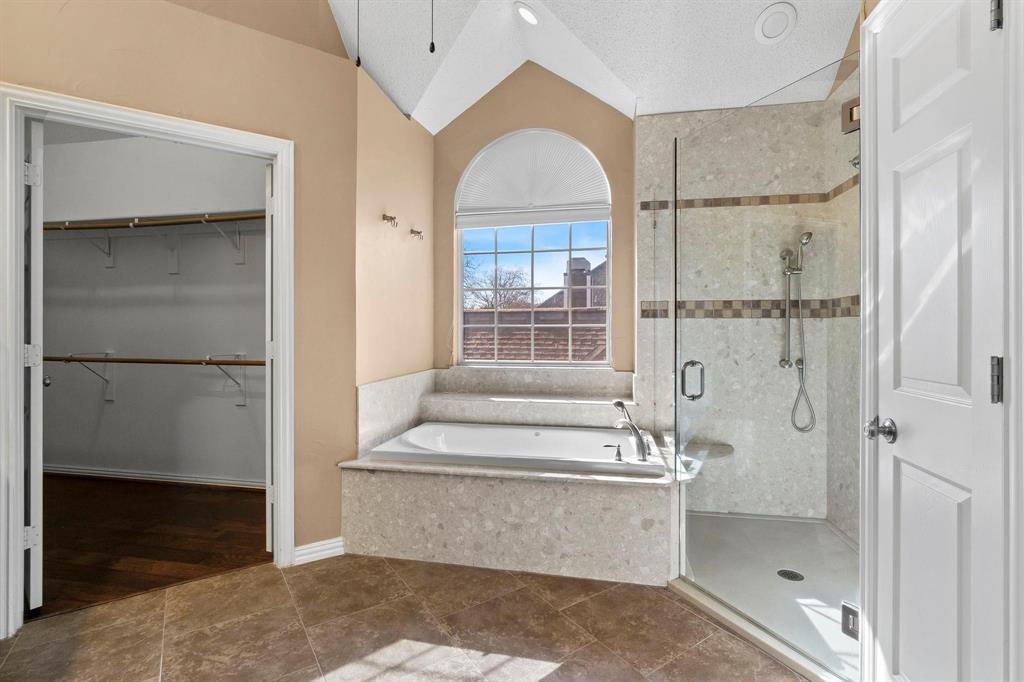 14588 Poe Court Addison, TX 75001 - Photo 11 of 28 a bathroom with a tub shower sink and mirror