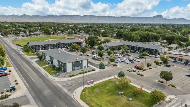 an aerial view of residential houses with outdoor space and ocean view