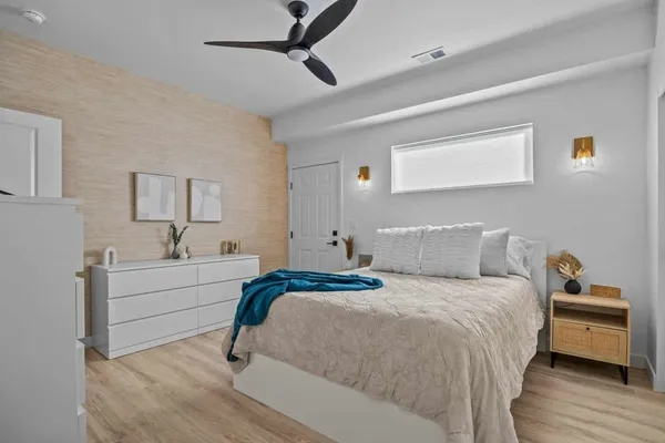 a bedroom with a bed and a table