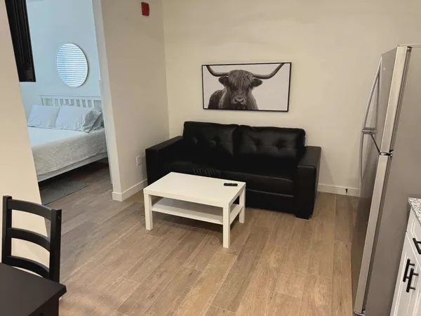 a living room with furniture and a wooden floor