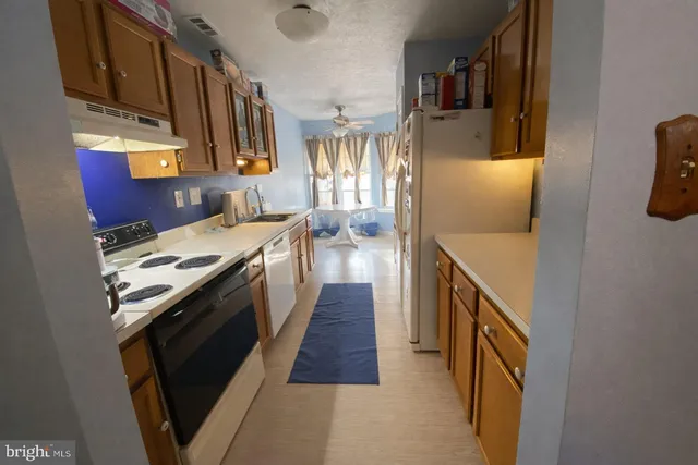 a kitchen with stainless steel appliances granite countertop a stove and a refrigerator