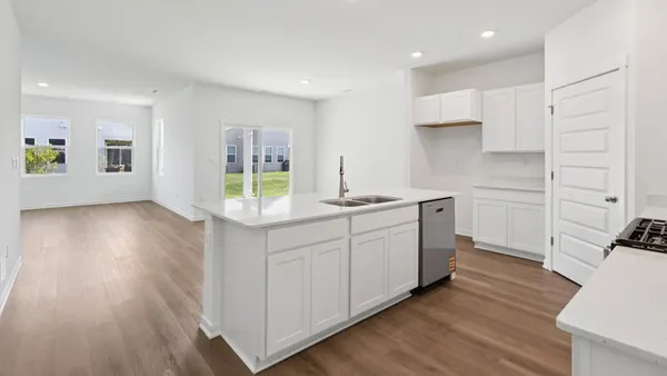a kitchen with wooden floors and white appliances
