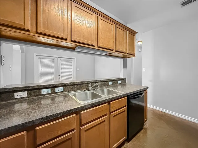 a kitchen with stainless steel appliances granite countertop a sink and cabinets
