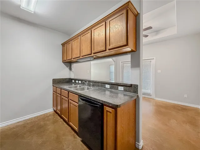 a kitchen with stainless steel appliances granite countertop a sink and a stove top oven