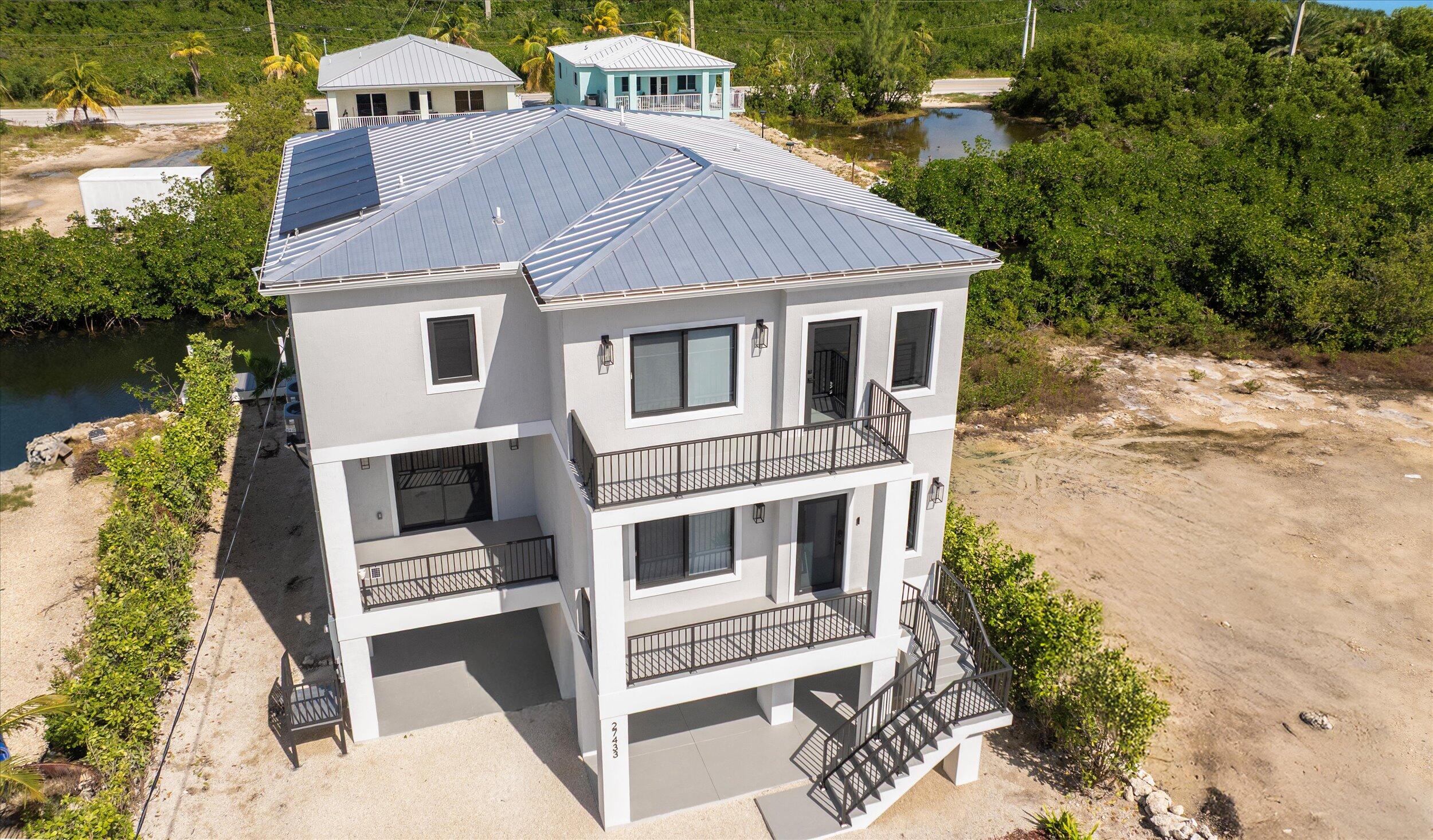 27433 Antigua Road Summerland Key, FL 33042 - Photo 5 of 64 a aerial view of a house with a yard and potted plants