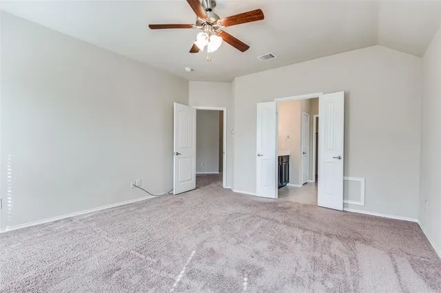 a view of a room with a ceiling fan and closet