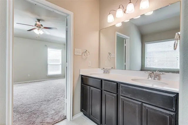 a bathroom with a double vanity sink and a mirror