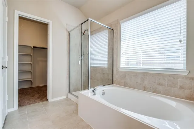 a bathroom with a bathtub and a shower