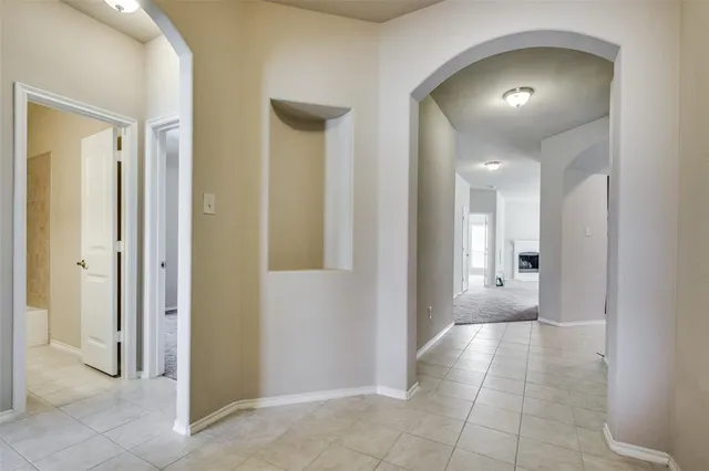 a view of a hallway with wooden shelves