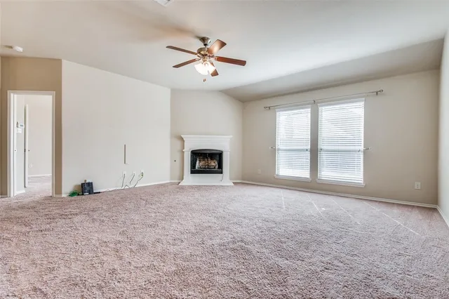 a view of empty room with window and fireplace
